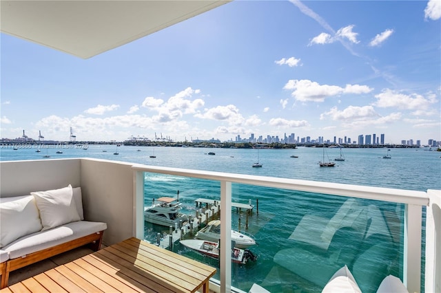 balcony with a view of city and a water view