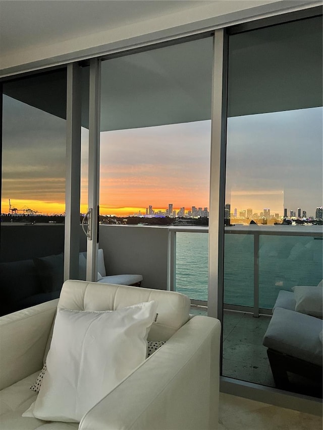 balcony at dusk featuring a view of city and outdoor lounge area