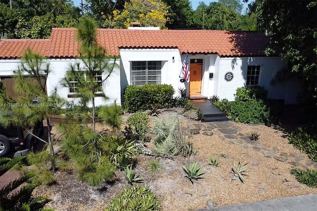 mediterranean / spanish-style home with stucco siding and a tile roof