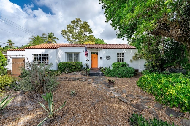 mediterranean / spanish-style house featuring a tile roof