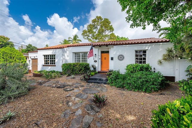 mediterranean / spanish-style home featuring brick siding and a tile roof