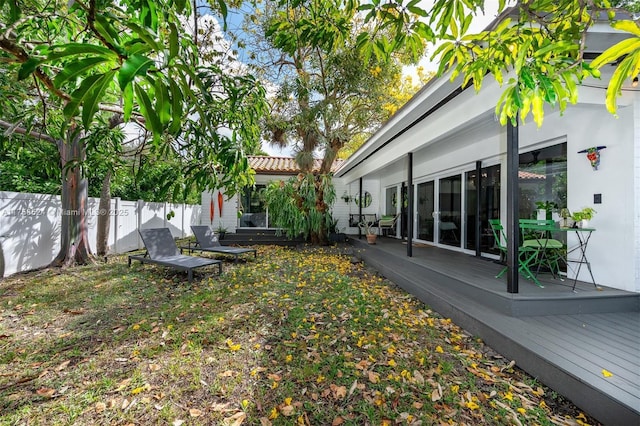 view of yard with a deck and fence