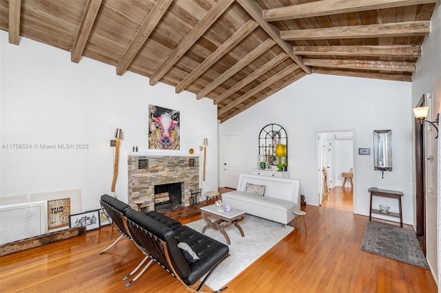 living area with beam ceiling, wooden ceiling, a fireplace, and hardwood / wood-style flooring