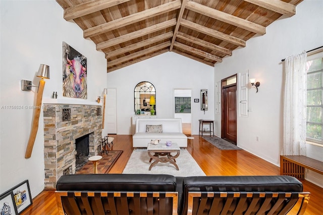 living room with wood finished floors, beam ceiling, wooden ceiling, and a fireplace