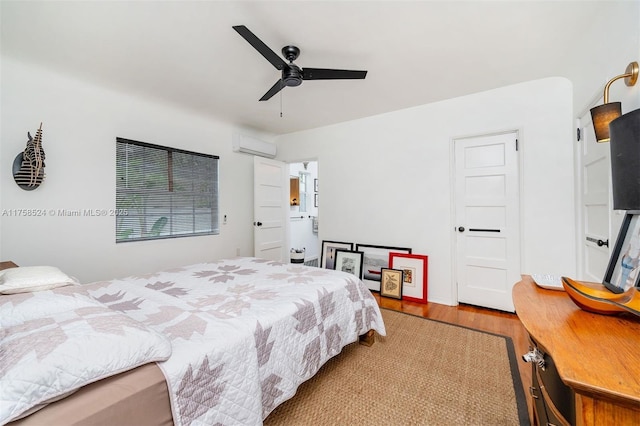 bedroom featuring ceiling fan, wood finished floors, and a wall mounted AC