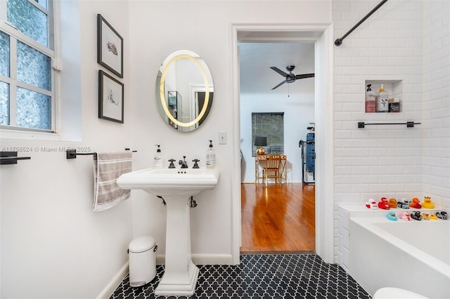 bathroom with a tub, ceiling fan, and tile patterned floors