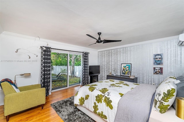 bedroom with crown molding, wood finished floors, and ceiling fan