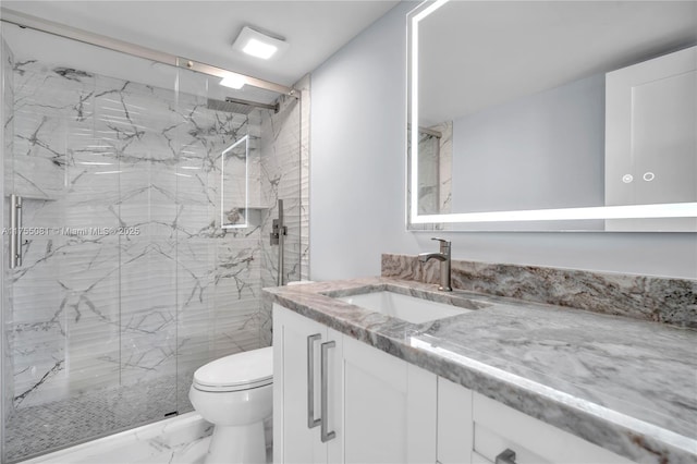 bathroom featuring marble finish floor, vanity, a marble finish shower, and toilet