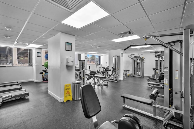 gym featuring visible vents, baseboards, and a drop ceiling