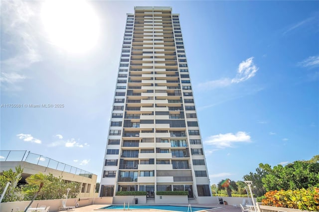 view of building exterior featuring a community pool