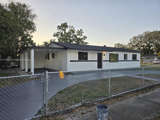 view of front facade featuring a fenced front yard, a gate, and stucco siding