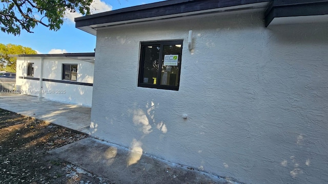 view of side of home featuring stucco siding