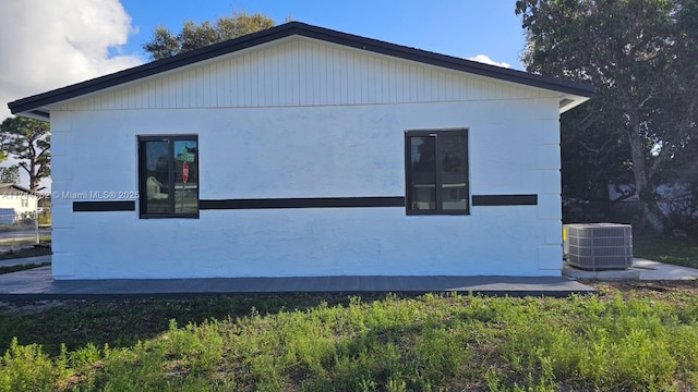 view of side of home featuring cooling unit