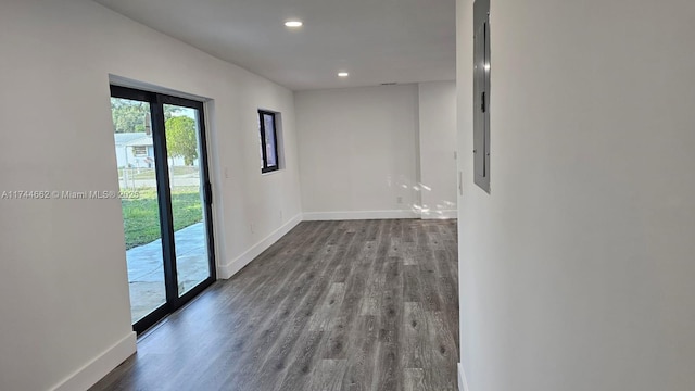 empty room featuring recessed lighting, dark wood finished floors, and baseboards