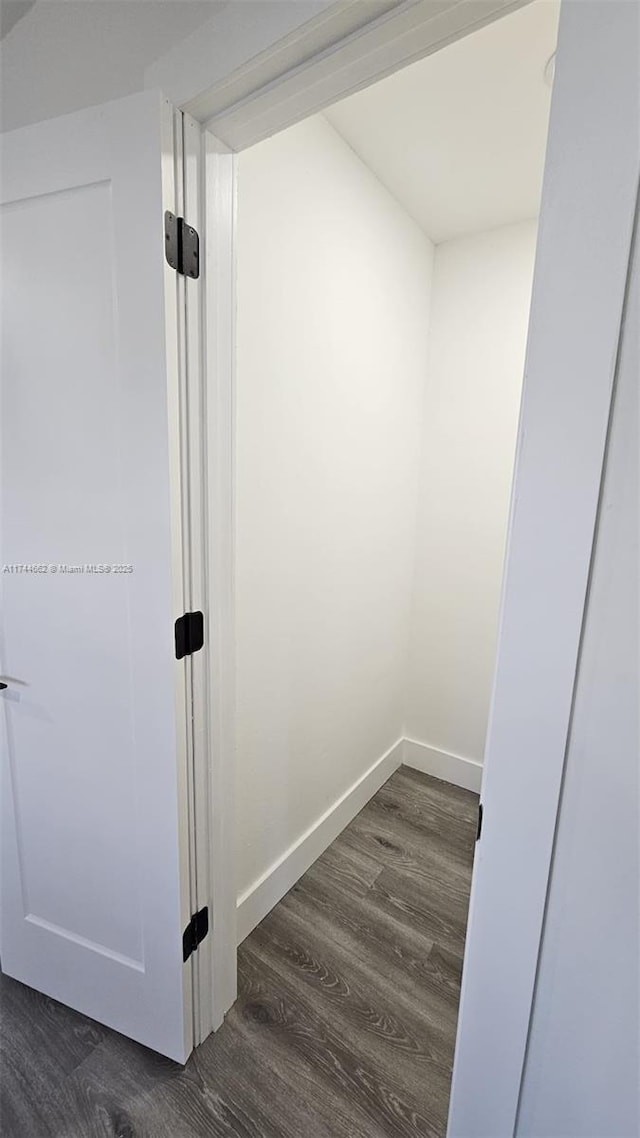 interior space with baseboards and wood finished floors