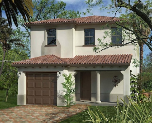 view of front of house featuring driveway, a tile roof, and stucco siding