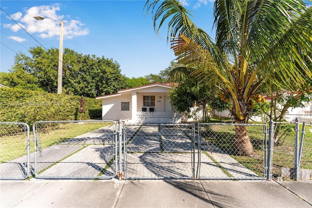 view of front of property with a fenced front yard, a gate, and stucco siding