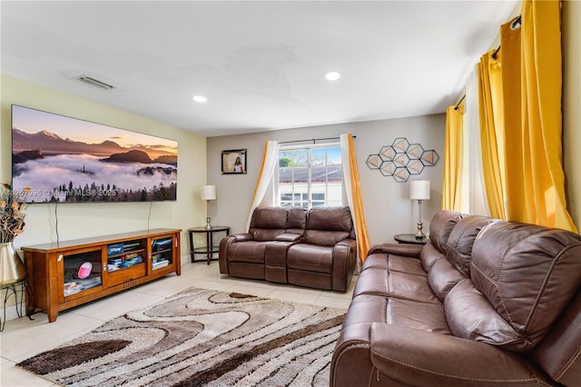 tiled living area with visible vents and recessed lighting