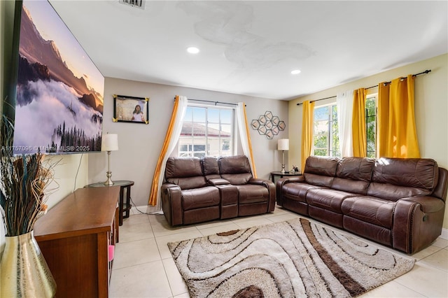 living room with recessed lighting, light tile patterned flooring, and a healthy amount of sunlight