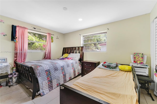 tiled bedroom featuring multiple windows