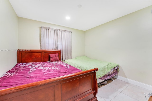 bedroom featuring baseboards and light tile patterned floors