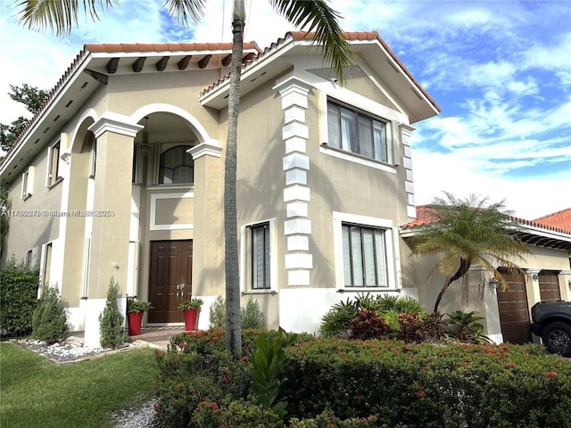 view of property exterior featuring stucco siding and a tile roof