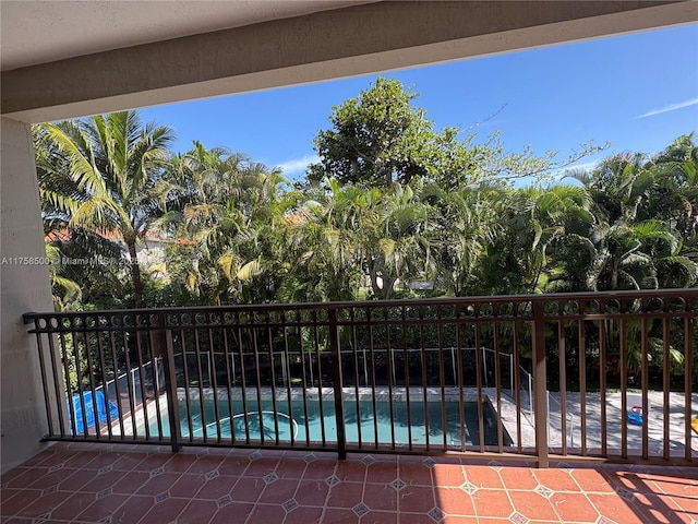 exterior space featuring a balcony and a fenced in pool