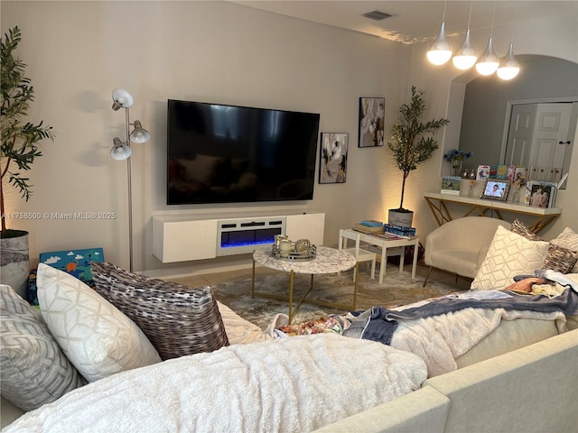 living room featuring tile patterned flooring and visible vents