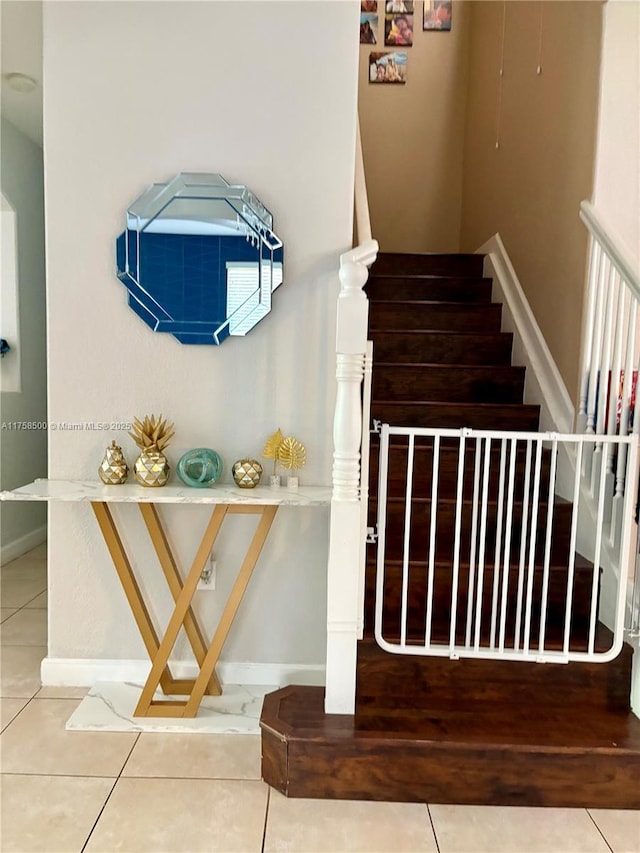 stairs with tile patterned flooring and baseboards