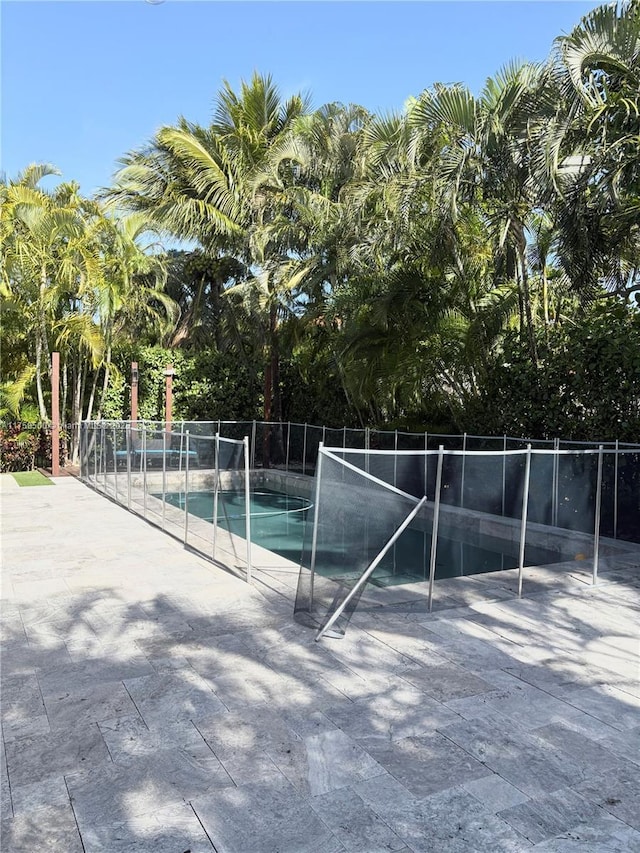 exterior space with a fenced in pool, a patio, and fence