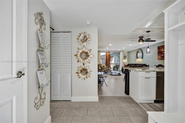 kitchen with pendant lighting, light tile patterned floors, white cabinets, ceiling fan, and light stone countertops