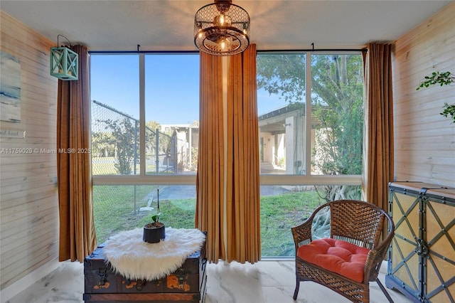 sunroom / solarium with a chandelier