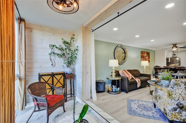 interior space featuring ceiling fan, wooden walls, recessed lighting, wood finished floors, and crown molding