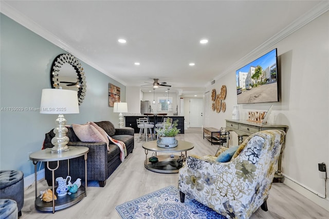 living area with baseboards, ornamental molding, wood finished floors, and recessed lighting