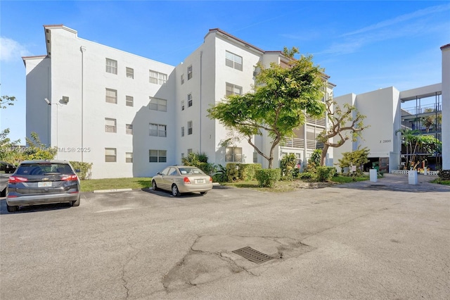 view of building exterior featuring uncovered parking