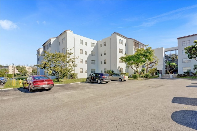 view of property featuring uncovered parking