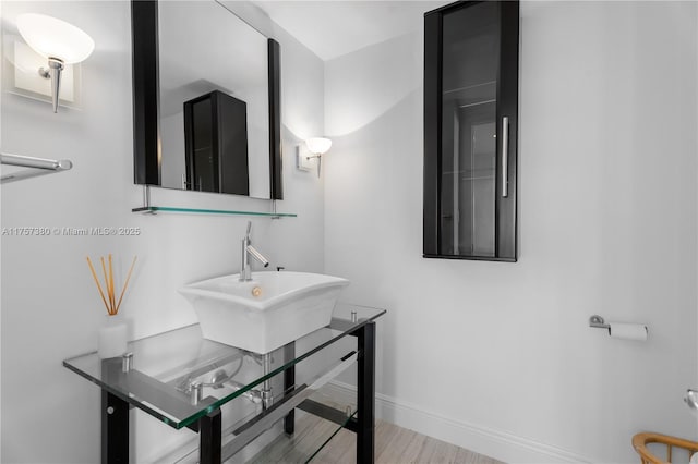 bathroom with baseboards and a sink