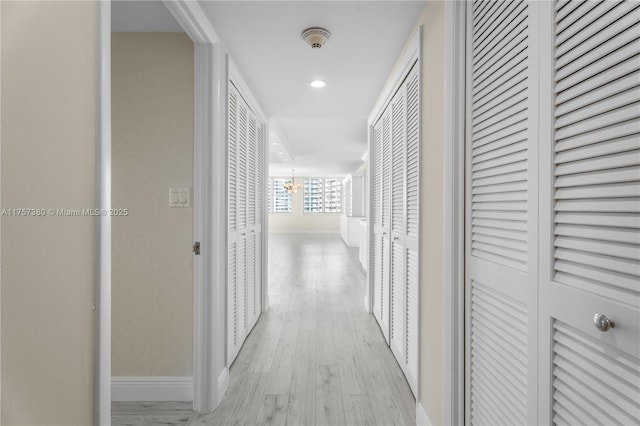 corridor with recessed lighting, baseboards, and light wood finished floors