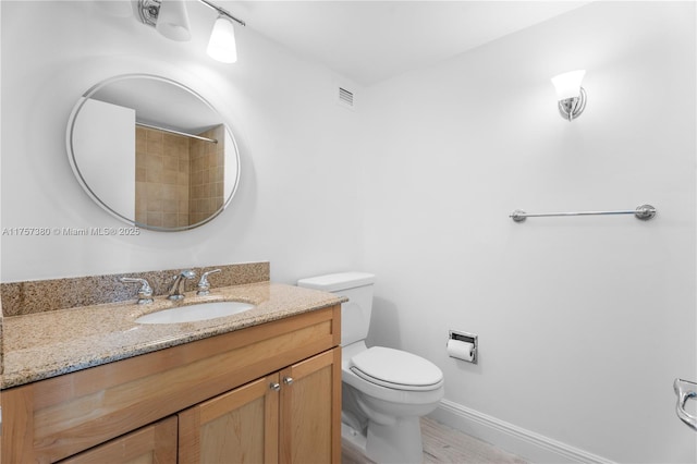 full bath featuring visible vents, toilet, vanity, wood finished floors, and baseboards