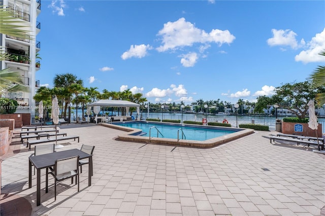 pool featuring a patio area, fence, and a gazebo