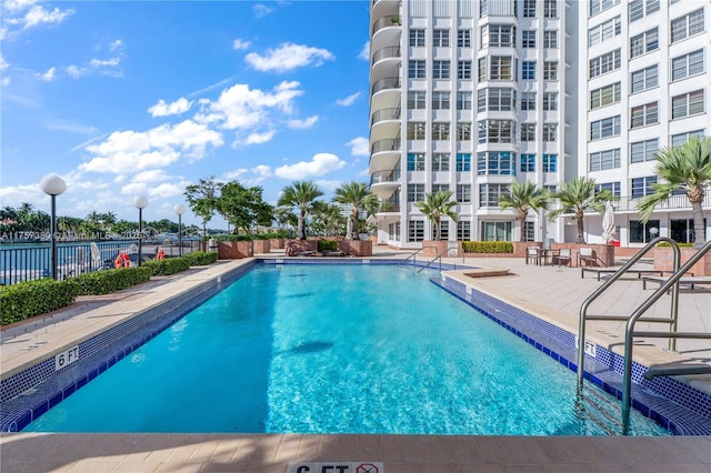 pool with fence and a patio