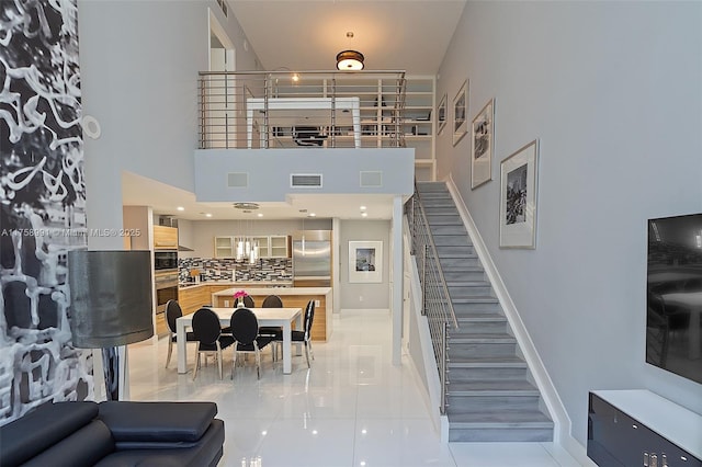 2020 N Bayshore Dr Unit Th 104, Miami, FL 33137 - staircase featuring tile patterned floors, baseboards, and a high ceiling