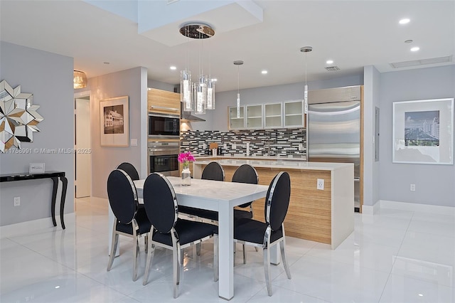 dining room with light tile patterned floors, baseboards, visible vents, and recessed lighting