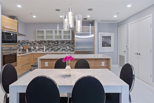 2020 N Bayshore Dr Unit Th 104, Miami, FL 33137 - kitchen featuring built in appliances, modern cabinets, decorative backsplash, glass insert cabinets, and recessed lighting