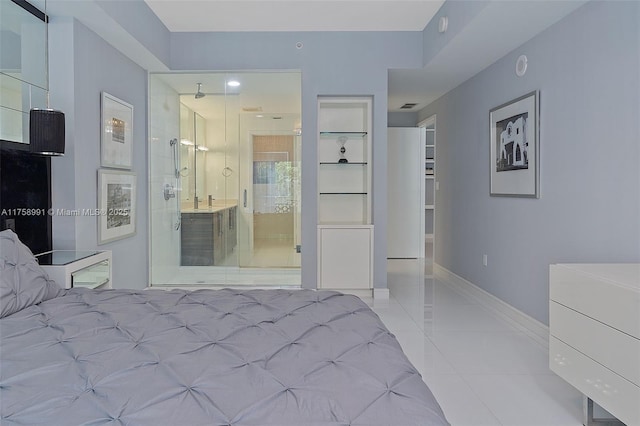 2020 N Bayshore Dr Unit Th 104, Miami, FL 33137 - bedroom with light tile patterned floors, baseboards, and connected bathroom