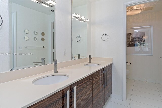 2020 N Bayshore Dr Unit Th 104, Miami, FL 33137 - bathroom with tile patterned flooring, double vanity, toilet, and baseboards