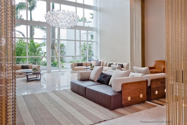 2020 N Bayshore Dr Unit Th 104, Miami, FL 33137 - living room featuring floor to ceiling windows, a towering ceiling, and a chandelier