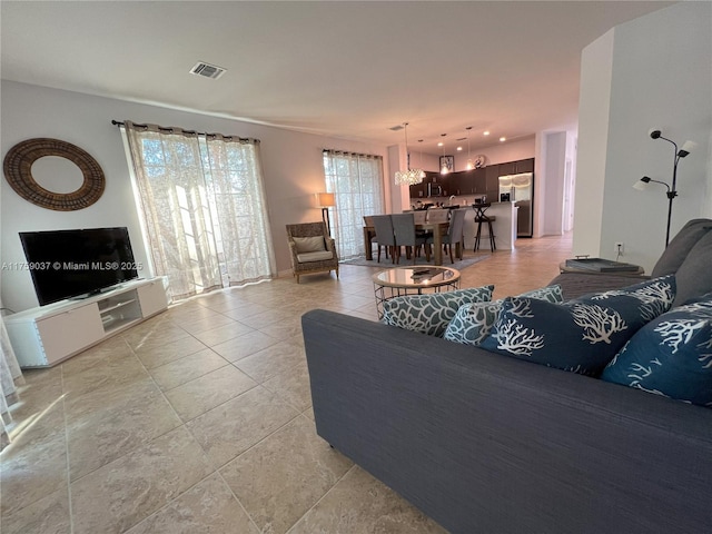 living room featuring light tile patterned flooring and visible vents