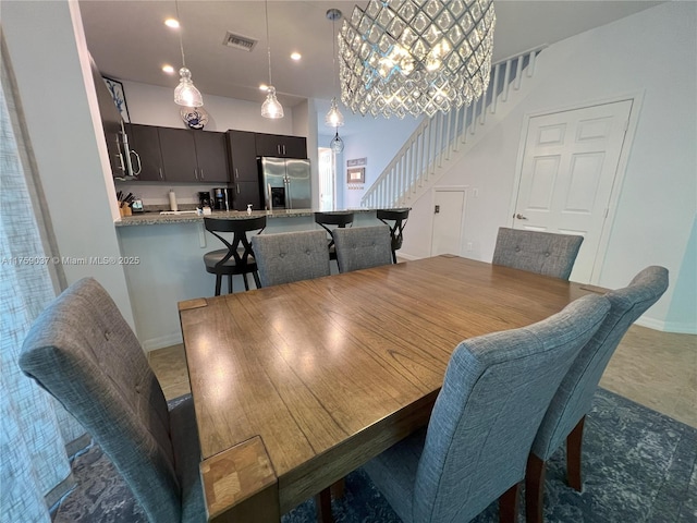 dining space with visible vents, stairway, and baseboards