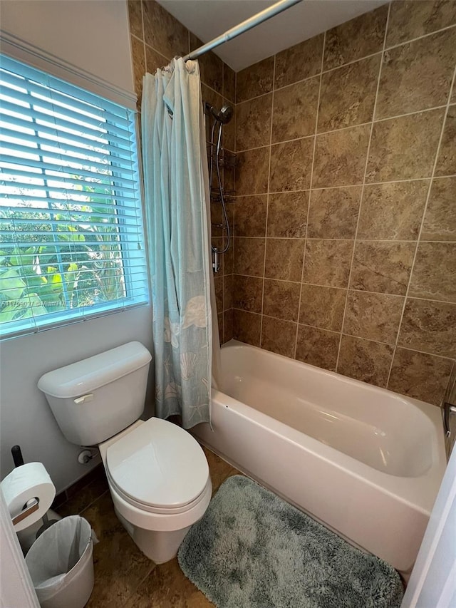 bathroom featuring shower / bath combination with curtain and toilet